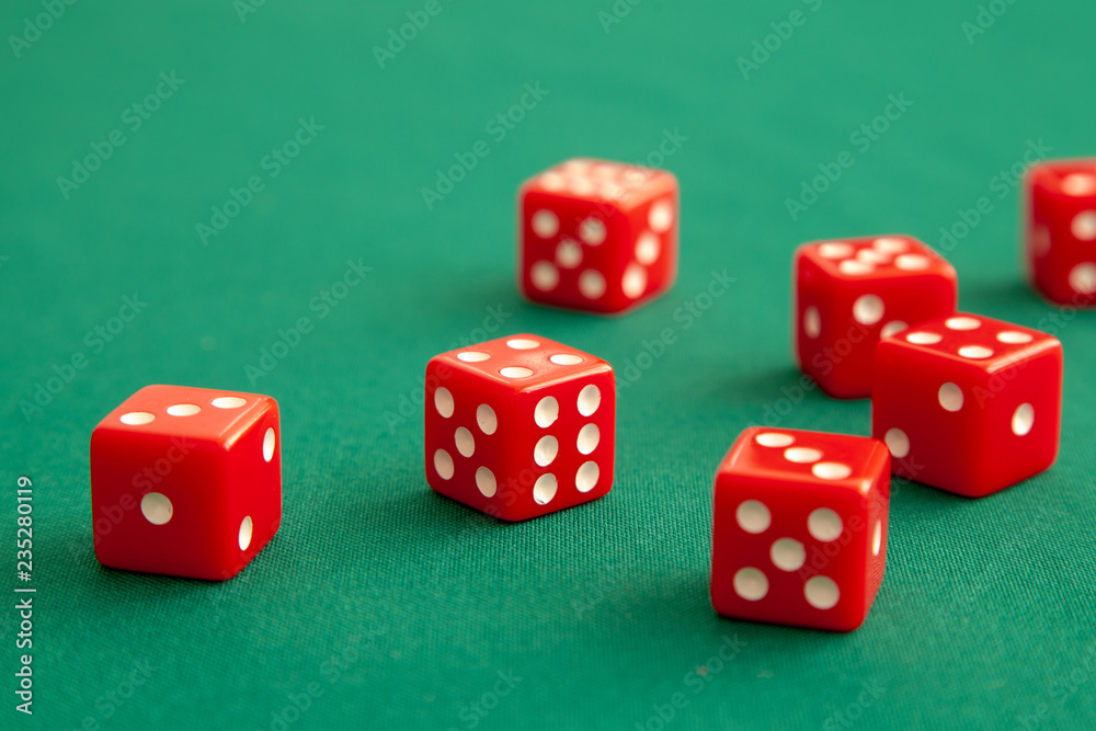 Red dices on green poker gaming table in casino. Concept online gambling Red dices on green poker gaming table in casino. Concept online gambling