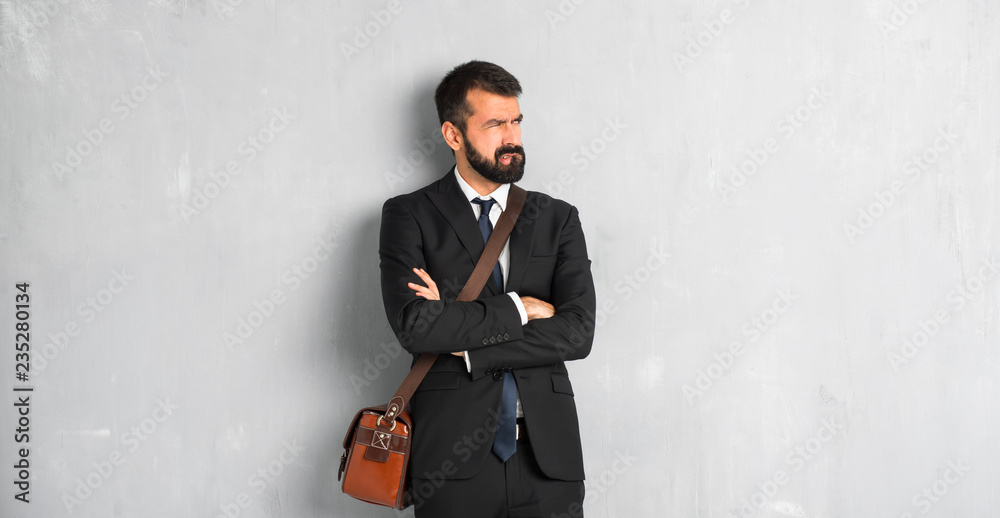 Businessman with beard with confuse face expression while bites lip Businessman with beard with confuse face expression while bites lip