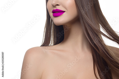 Close-up of woman's lips with fashion bright pink make-up. Beautiful female mouth, full lips with perfect makeup. Part of female face. Choice lipstick and Pink wavy hair of a doll