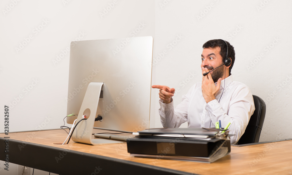 Telemarketer man in a office pointing with finger at someone and laughing Telemarketer man in a office pointing with finger at someone and laughing