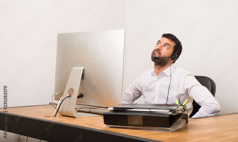 © luismolinero - Telemarketer man in a office looking up with serious face