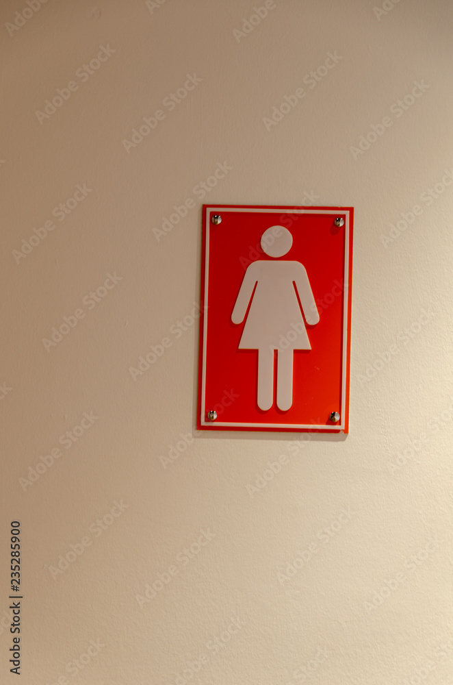 Female Sign on toilet wall