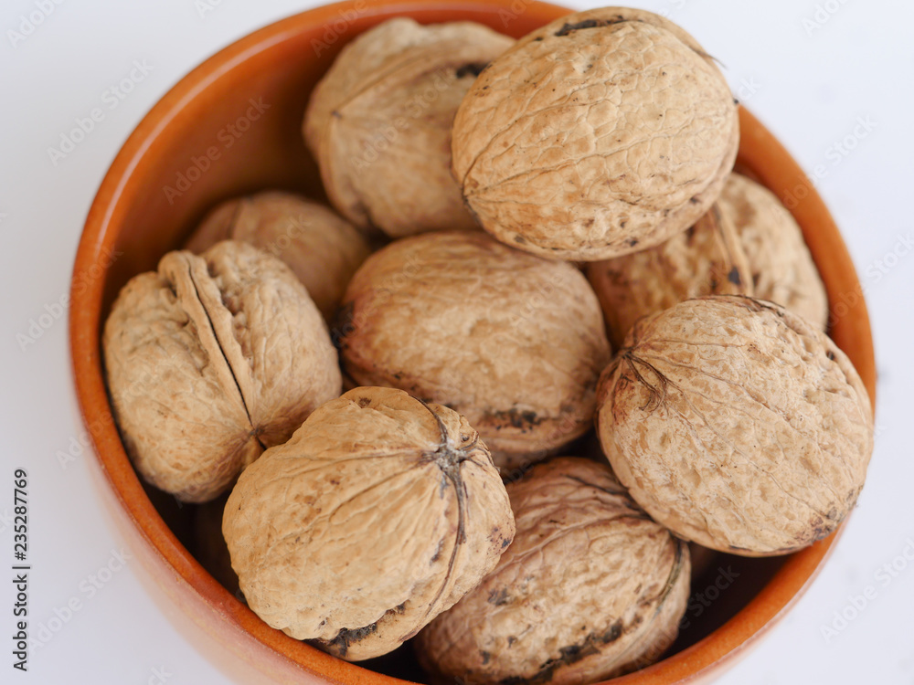 Organic walnuts in a ceramic bowl Organic walnuts in a ceramic bowl