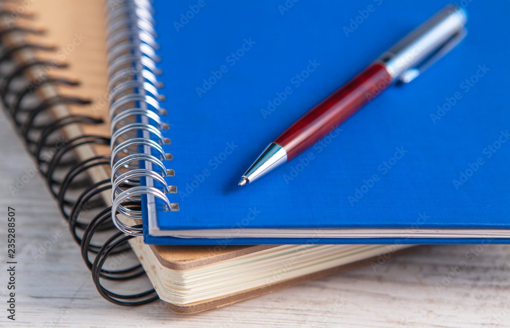 notebook and pen in wooden background notebook and pen in wooden background