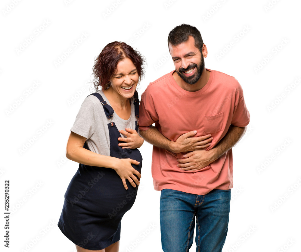 Couple with pregnant woman smiling a lot while putting hands on chest on isolated white background Couple with pregnant woman smiling a lot while putting hands on chest on isolated white background