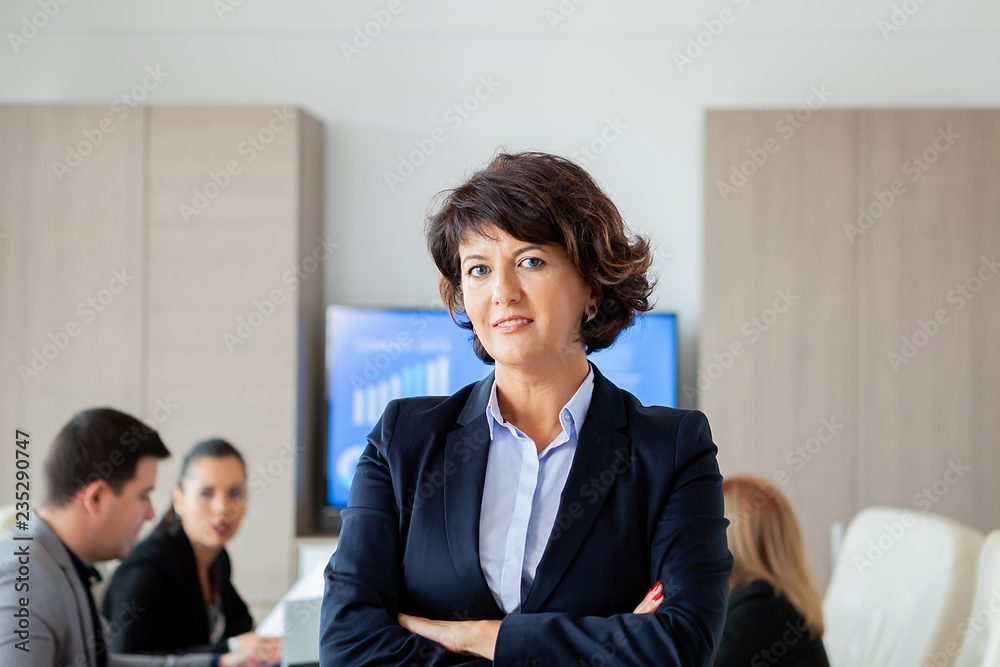 Middle aged business woman in conference room. Woman suit. Middle aged business woman in conference room. Woman suit.