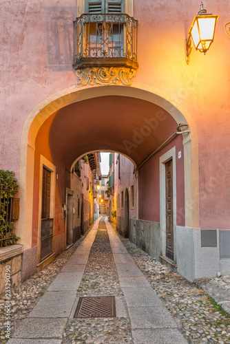 Beautiful scenic alley with historic and traditional houses and cobbled street. Picturesque Italian village, Orta San Giulio (street Giovanetti), on lake Orta, north Italy © AleMasche72
