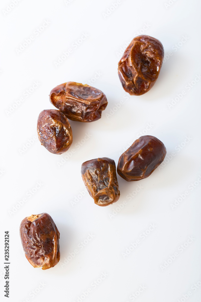 Dried halawi dates on a white Dried halawi dates on a white
