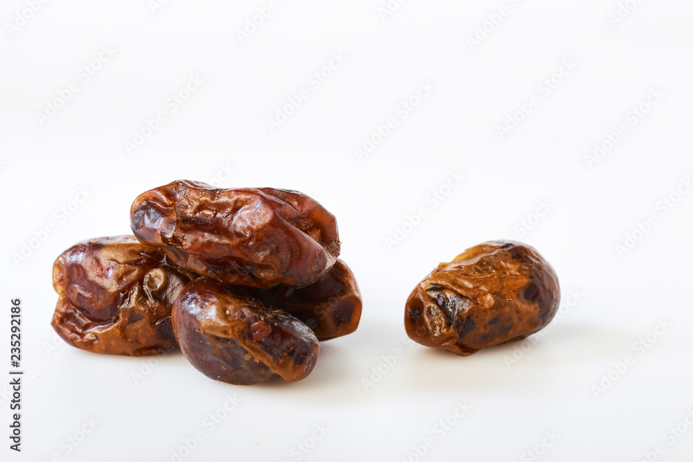 Dried halawi dates on a white Dried halawi dates on a white