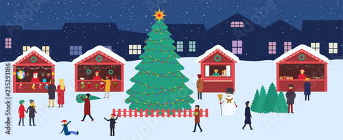 Christmas market with souvenir stalls and a large сhristmas tree in evening city square. Festive winter shopping, celebrations at city fair on eve of New Year.