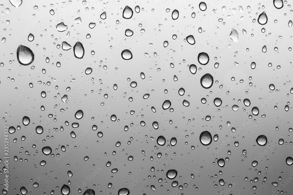Water drops on a transparent glass background, abstract pattern