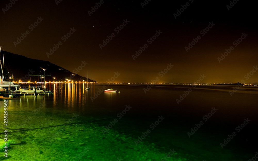 Night view of Lake Garda and the illuminated villages on the west coast.