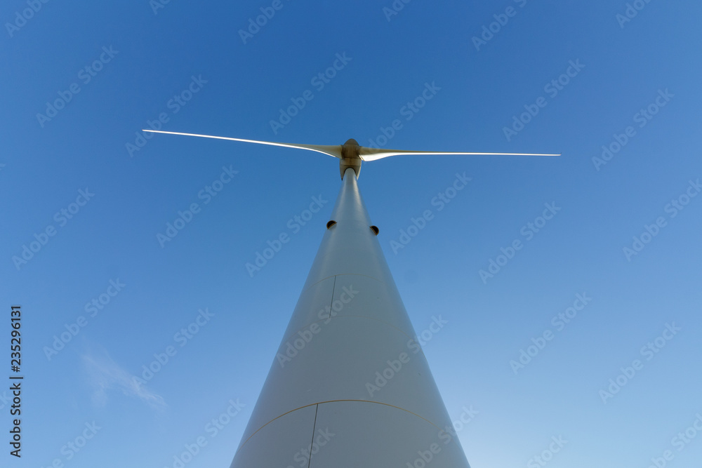Underside of wind turbine against blue sky in portugal Underside of wind turbine against blue sky in portugal