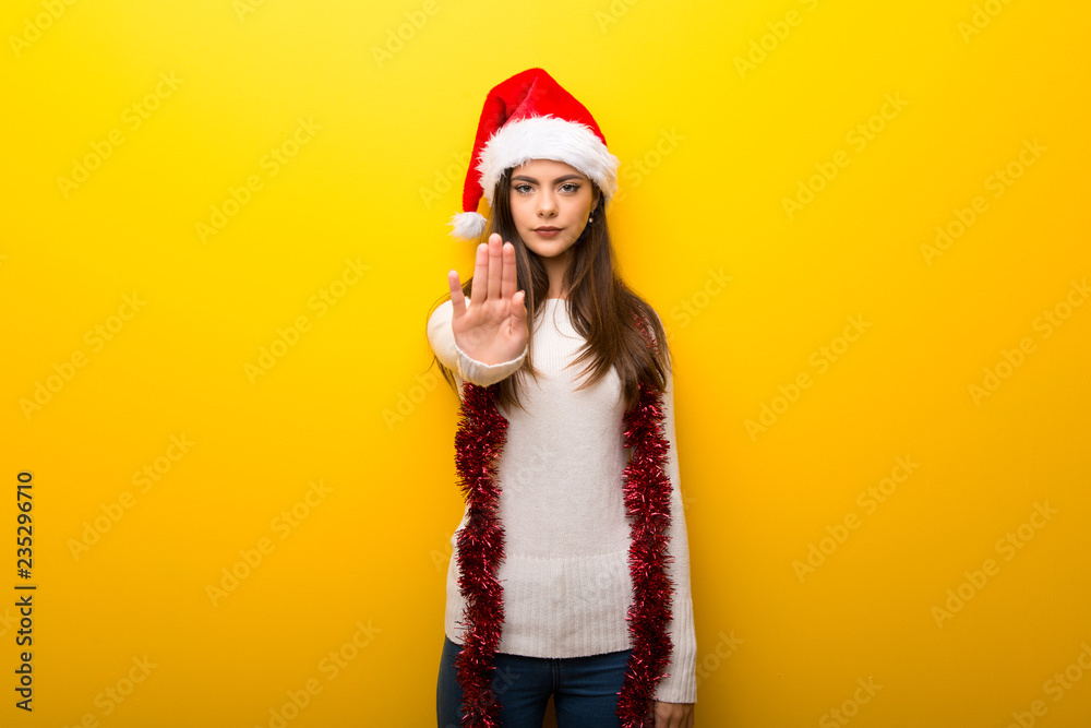 Fototapeta premium Teenager girl celebrating christmas holidays making stop gesture with her hand