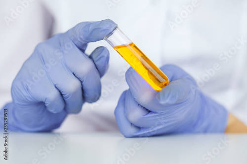 Biological test. Woman holding flask in lab. The scientist,dermatologist testing the organic natural product in the laboratory