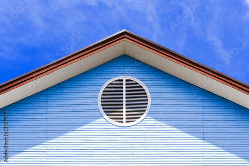 Gable of house with air ventilate on blue sky backgroung