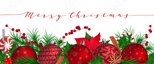 Merry Christmas. Festive red Christmas Balls in row with fir decoration, candy cane, lolly pop, holly, Poinsettia, berries, cinnamon