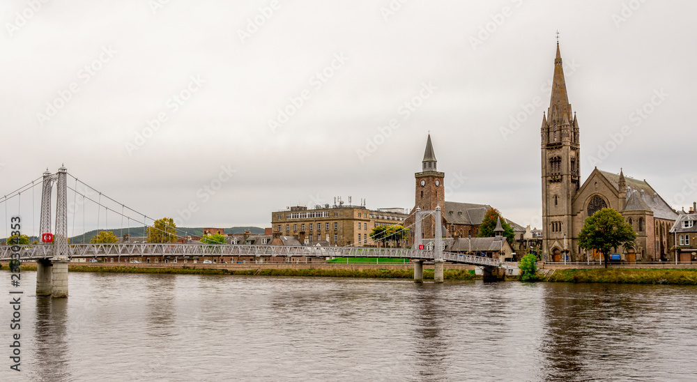 Bridge over river Ness and two churches on an opposite bank, Inverness, Scotland