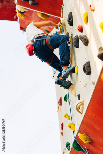 Young caucasian man rock climbing outdoor