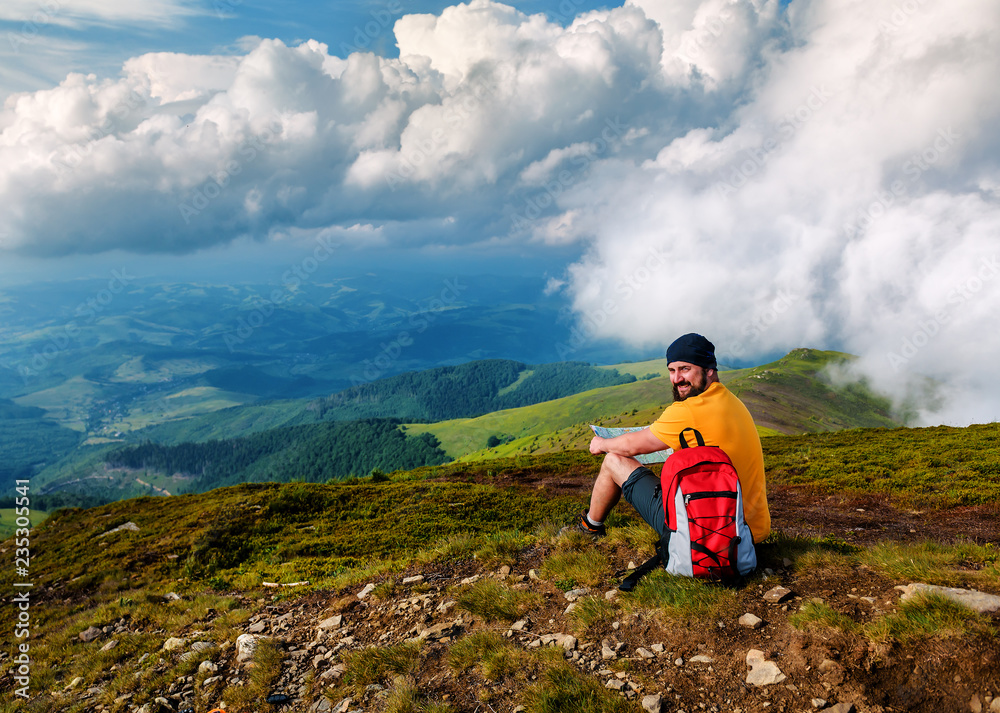 man with map on the mountain top