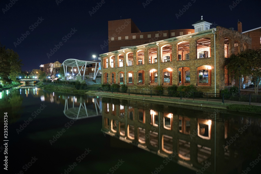 Buildings in downtown Greenville South Carolina reflecting in the waters of the Reedy River in downtown Greenville, South Carolina