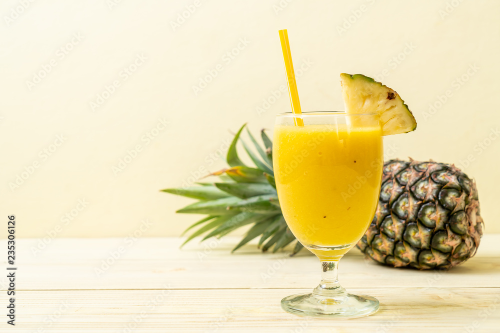 Fototapeta premium fresh pineapple smoothie glass on wood table
