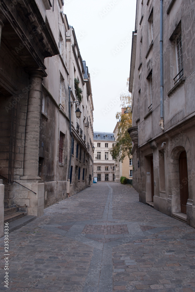 Narrow pedestrian street in an old city.