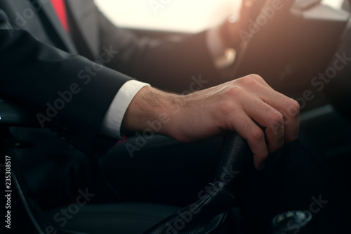 Close-up - Businessman at the wheel of new car