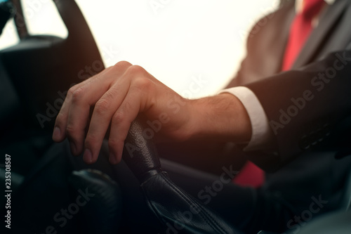 Close-up - Businessman at the wheel of new car