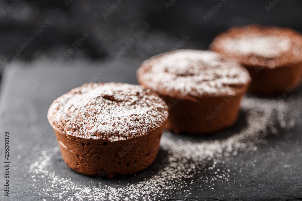 Classic chocolate fondant on a dark background. Chocolate muffins Classic chocolate fondant on a dark background. Chocolate muffins