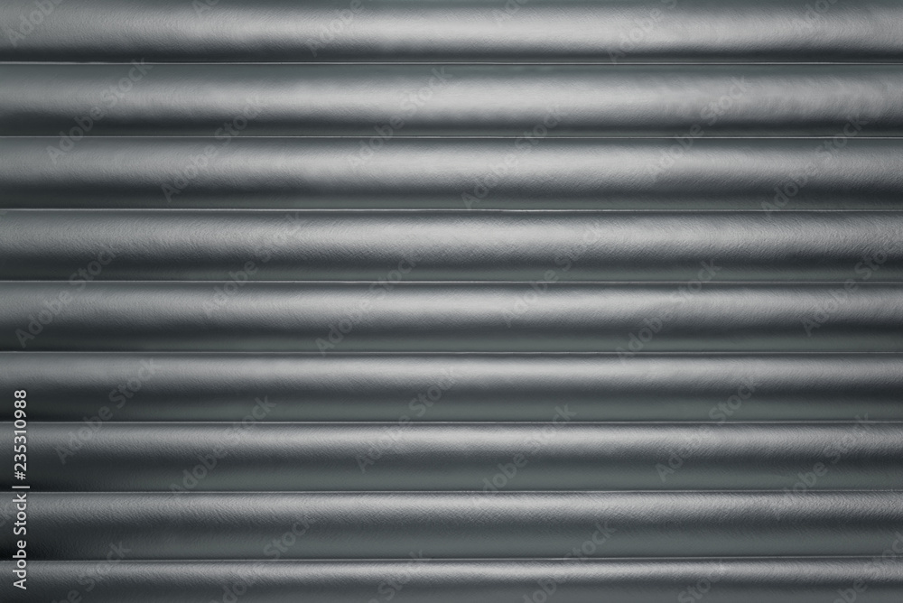Fototapeta premium Abstract silver background with horizontal lines, lit with a soft light.