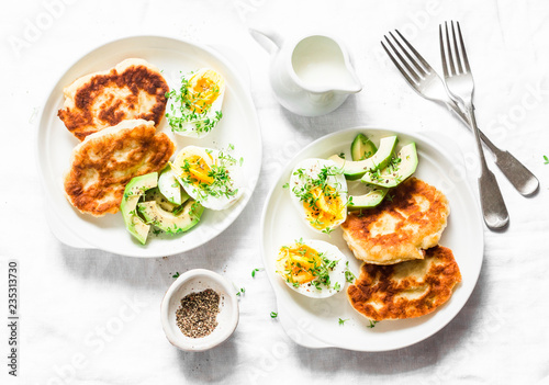 Served brunch table - potato scones and boiled eggs on a light background, top view. Delicious breakfast, snack, appetizer