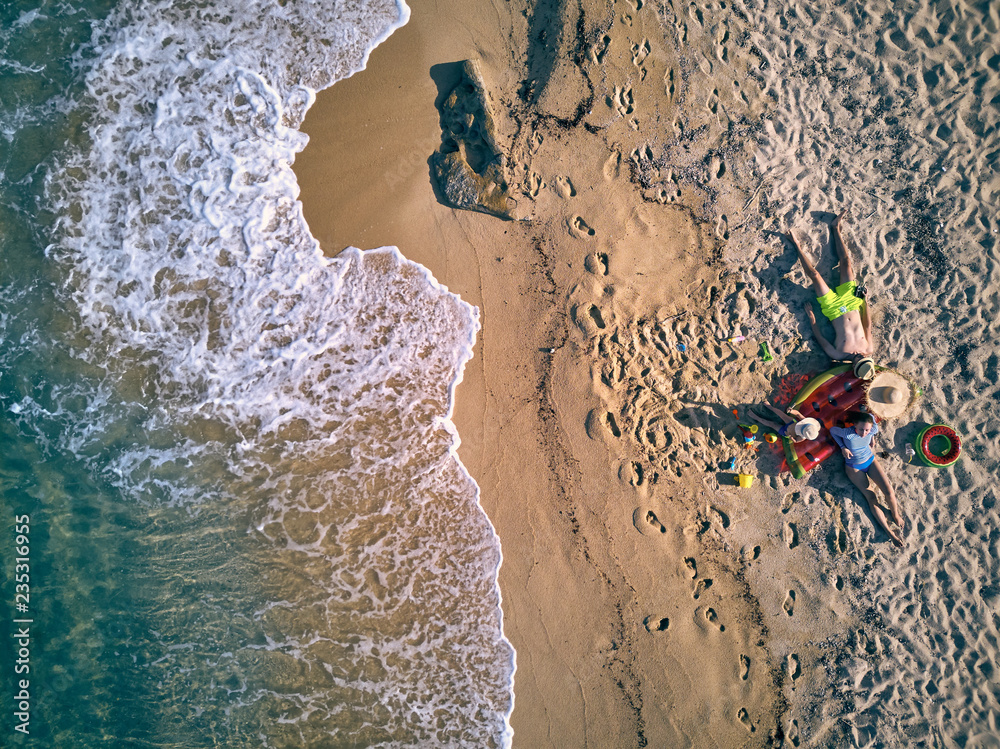 Beautiful beach with family top view shot Beautiful beach with family top view shot