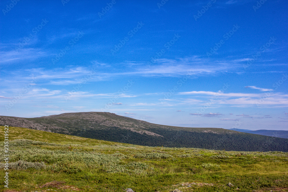 Beautiful view for postcards. Beautiful mountainscape scenery and blue sky. Mountains and plains of the Northern Urals.