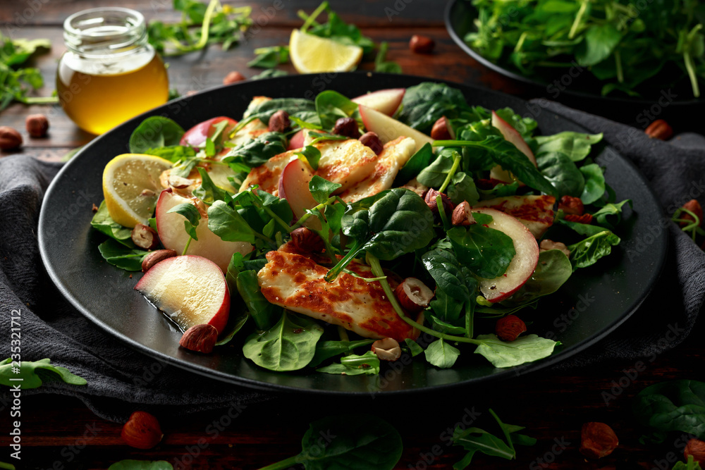 Grilled Halloumi Cheese salad with peach fruit, nuts and spinach, arugula mix. healthy food Grilled Halloumi Cheese salad with peach fruit, nuts and spinach, arugula mix. healthy food
