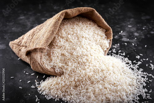 White raw basmati rice in burlap bag photo