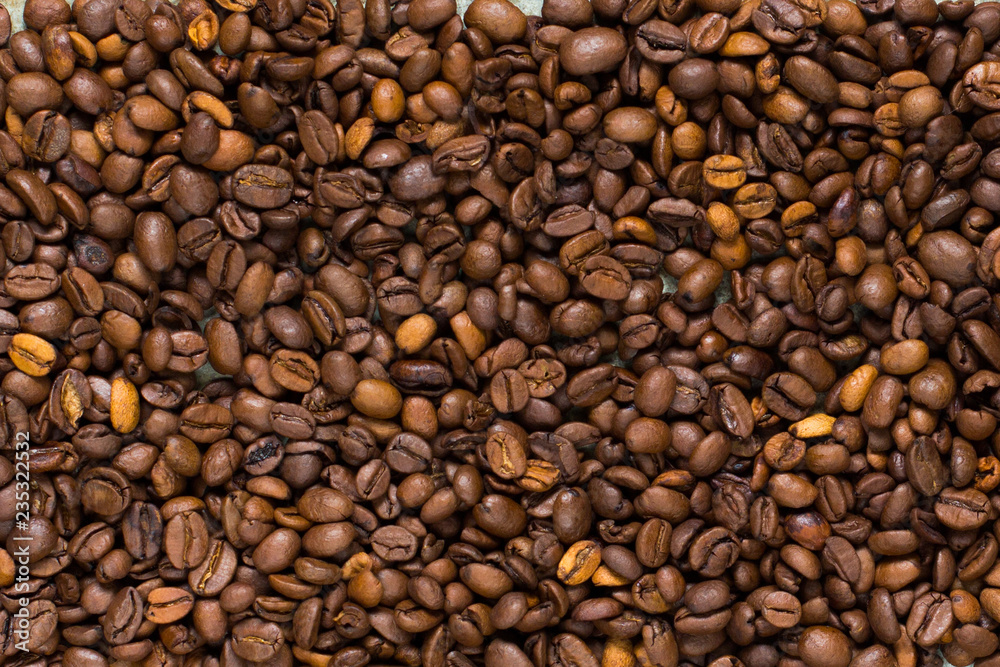 coffee grain (good and bad grain) - Arabica and Robusta blend (roasted coffee grain). Black background. Top view . Copy space.