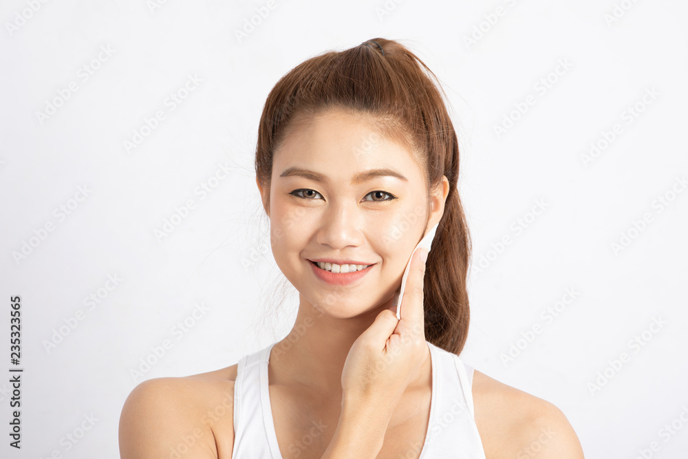 Attractive Charming Asian young woman smile and using tissue with toner for cleaning make up feeling so fresh and clean with healthy skin,isolated on white background,Beauty Cosmetics Concept Attractive Charming Asian young woman smile and using tissue with toner for cleaning make up feeling so fresh and clean with healthy skin,isolated on white background,Beauty Cosmetics Concept