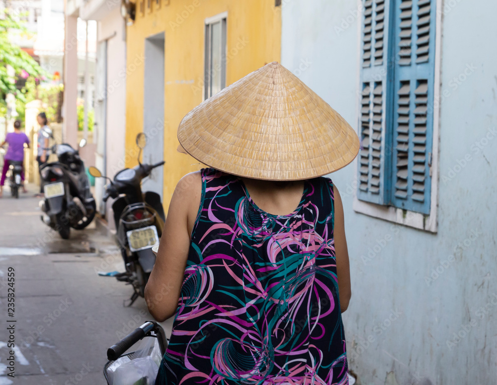 rear view of vietnamese woman in traditional conical hat