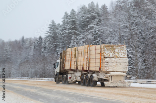 Logging truck on the highway in winter.
