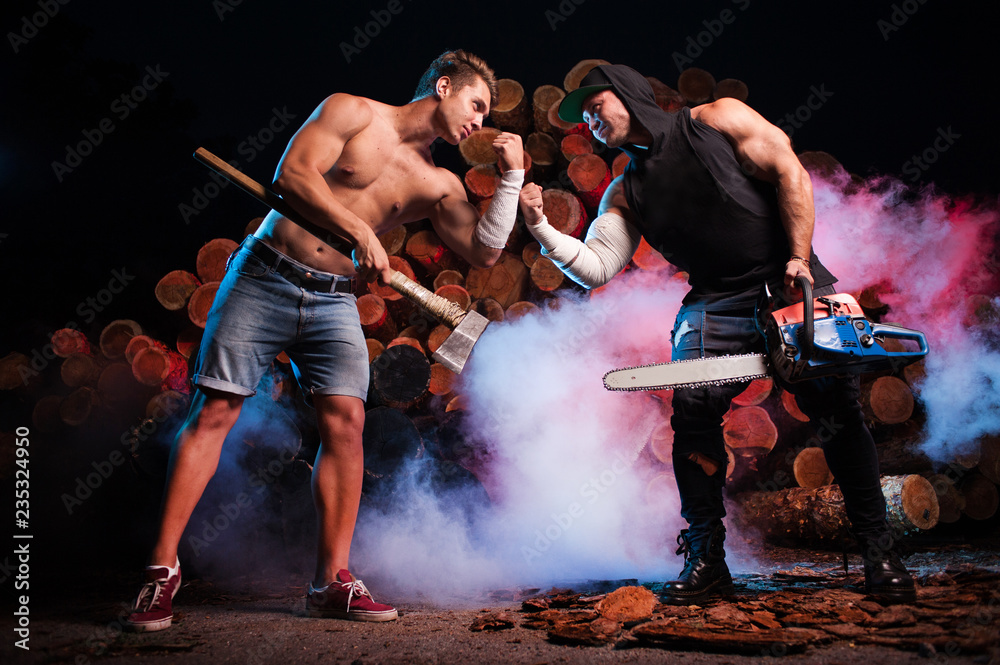 Two lumberjacks measure their own hands the background of firewood