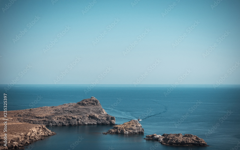 Small rocks go from sea next to Lindos town on Rhodes