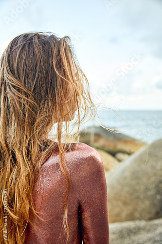 Woman's Back Covered By Golden Glitter