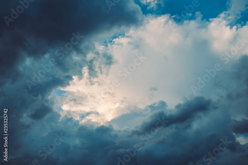 Dark blue stormy dramatic clouds in sky with copy space. For background and wallpaper