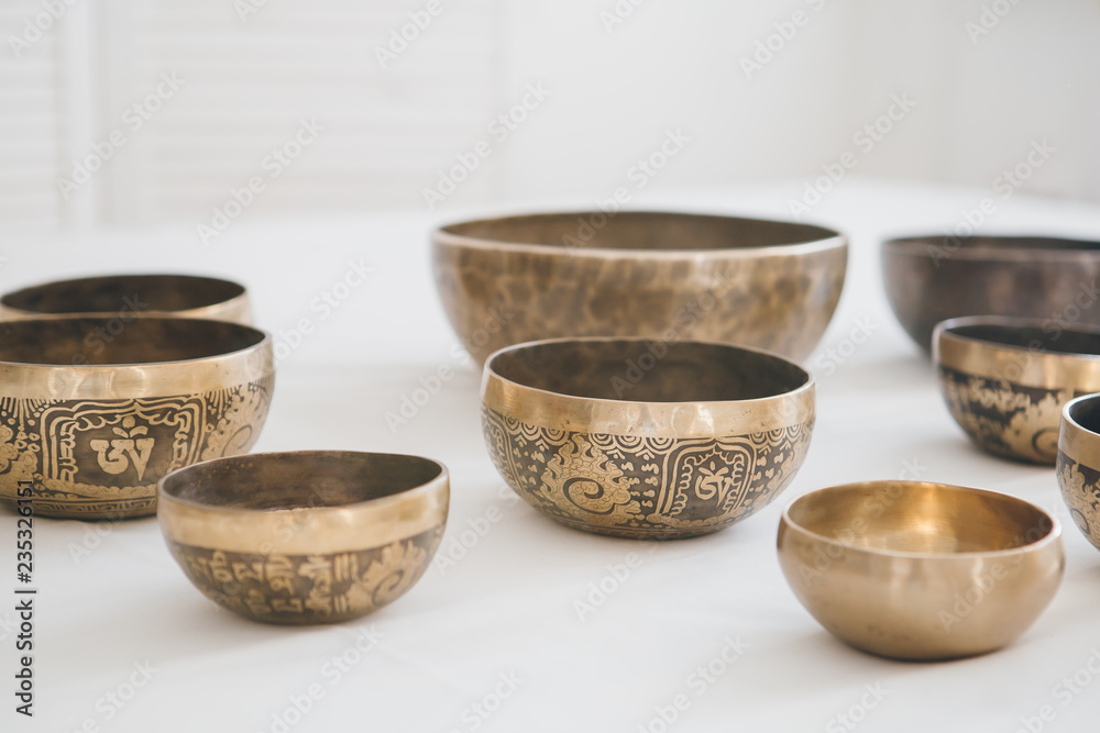 Tibetan singing bowls on white background in Spa Tibetan singing bowls on white background in Spa