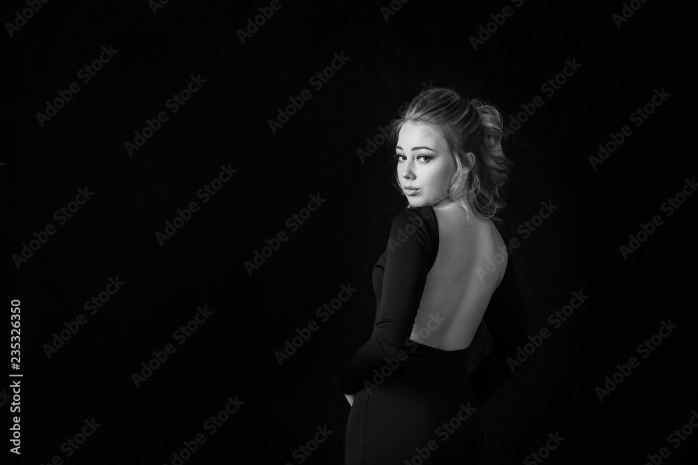 portrait of beautiful elegant girl behind on black background, sexy girl back