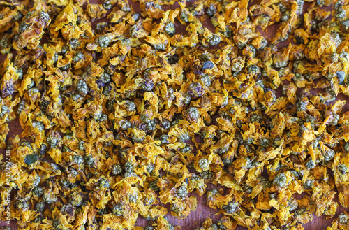 dried yellow chrysanthemum flower background. Chrysanthemum tea is a herbal tea made from chrysanthemum which belongs to aromatic Chinese medicine.