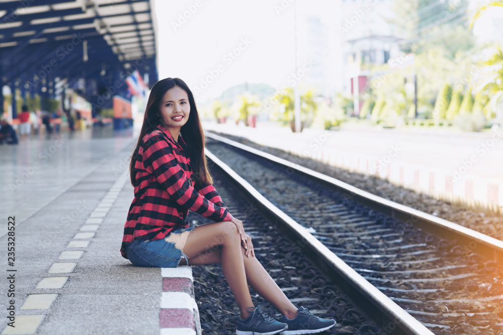 Tourists are waiting for the train alone. Travel concept. Tourists are waiting for the train alone. Travel concept.