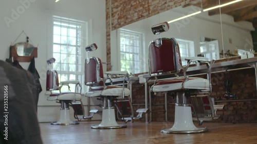 Interior of hairdresser barber shop with empty chairs. Retro styled interior of hair salon.