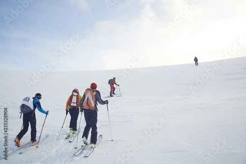 Skitouring group with mountain views in winter